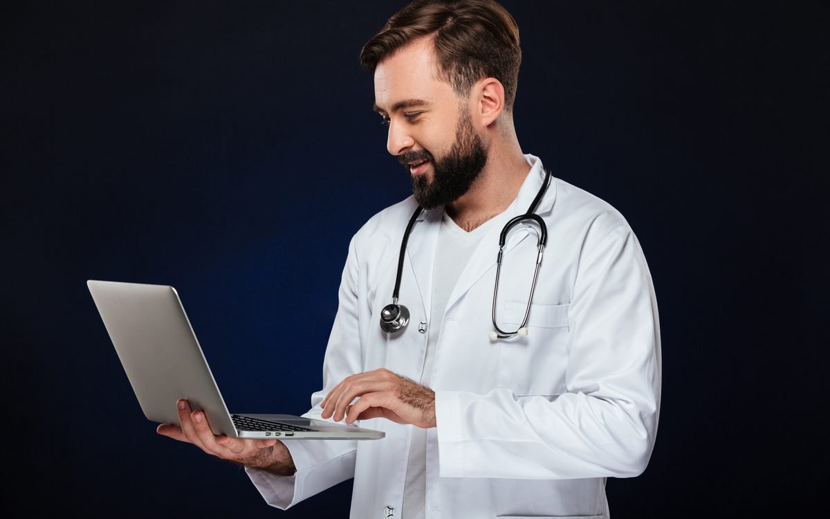 Doctor reviewing patient bookings on a laptop